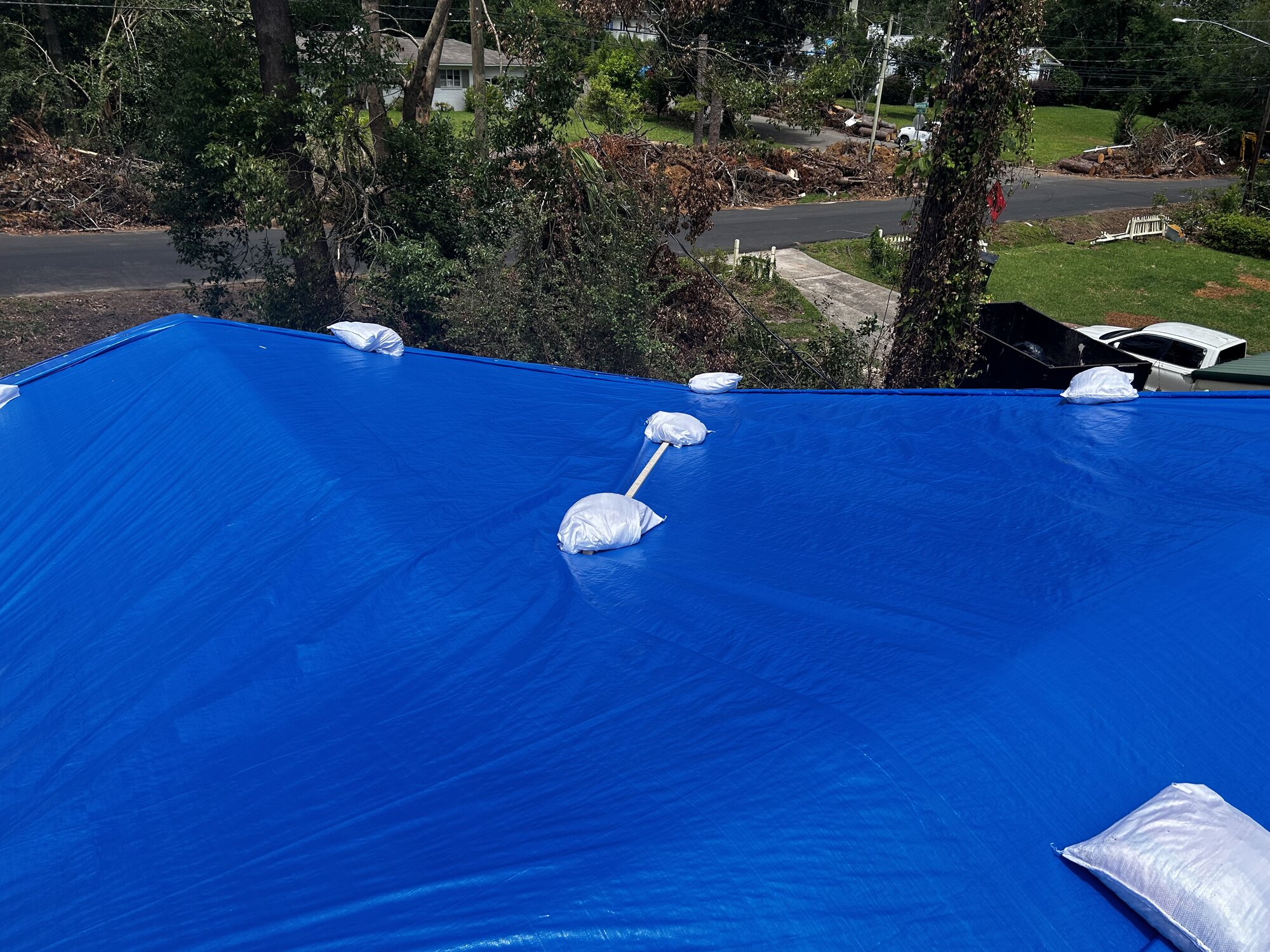 Coastal storm protection - non-destructive sandbag tarping method