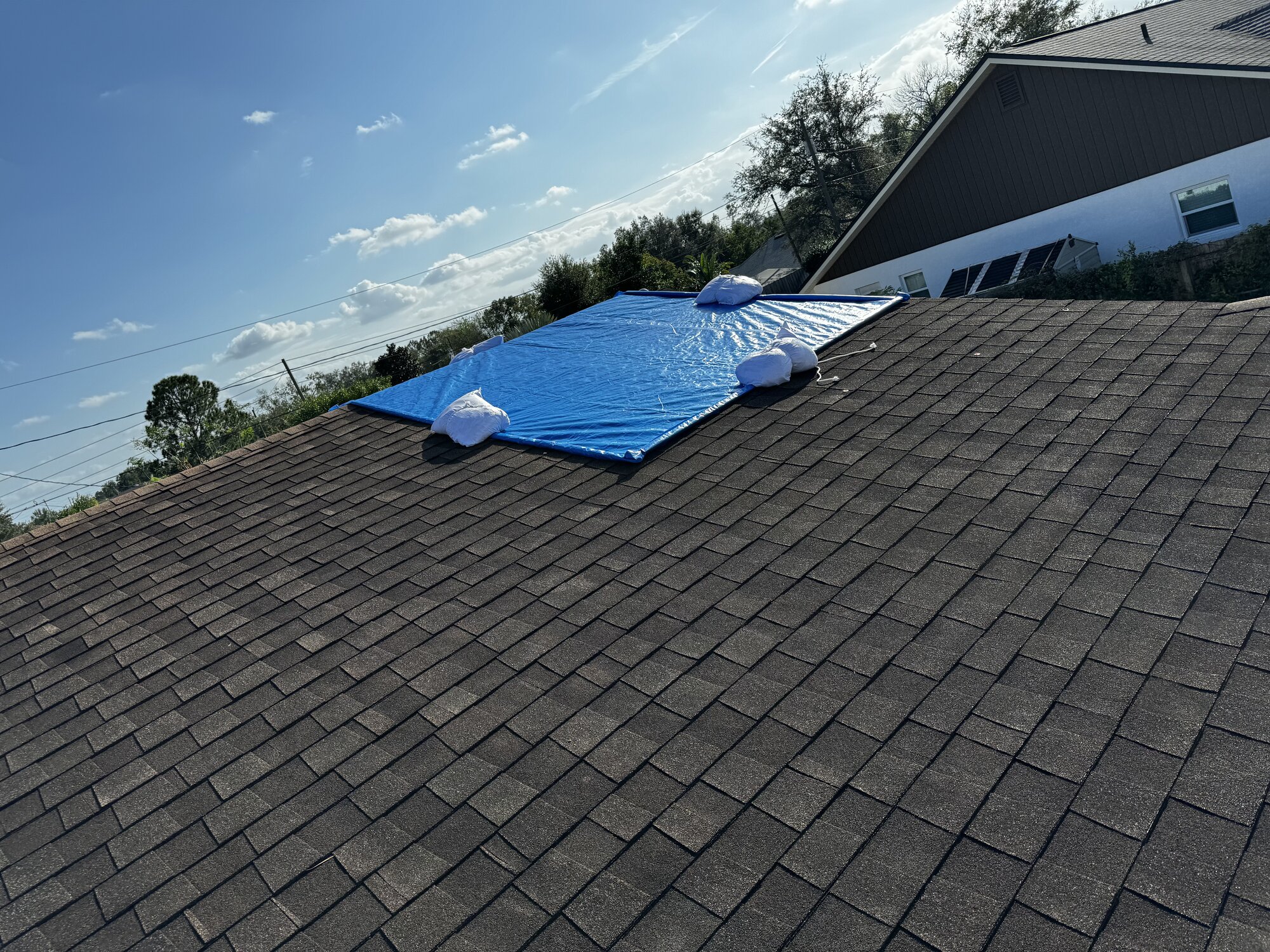 Hurricane damage mitigation - professional tarping for insurance processing